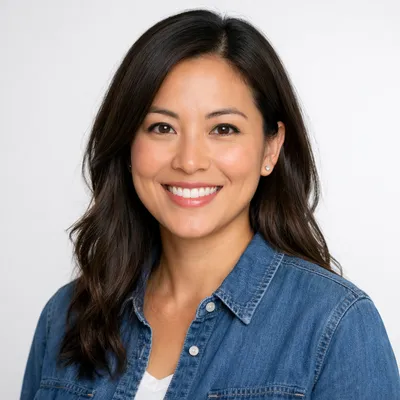 Professional headshot of a diverse adult with friendly expression, studio lighting, light background